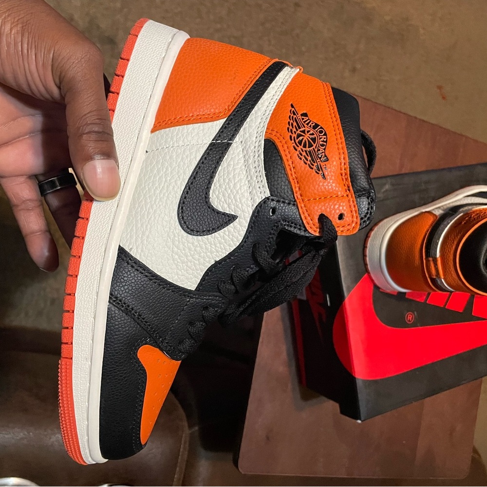 Women’s Jordan Orange, Black, and White Sneakers